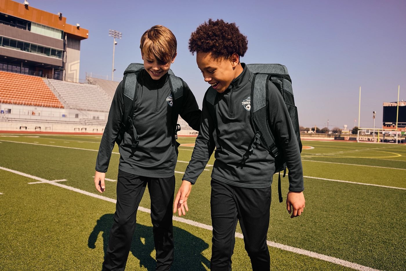 Two young athletes in coordinated team apparel