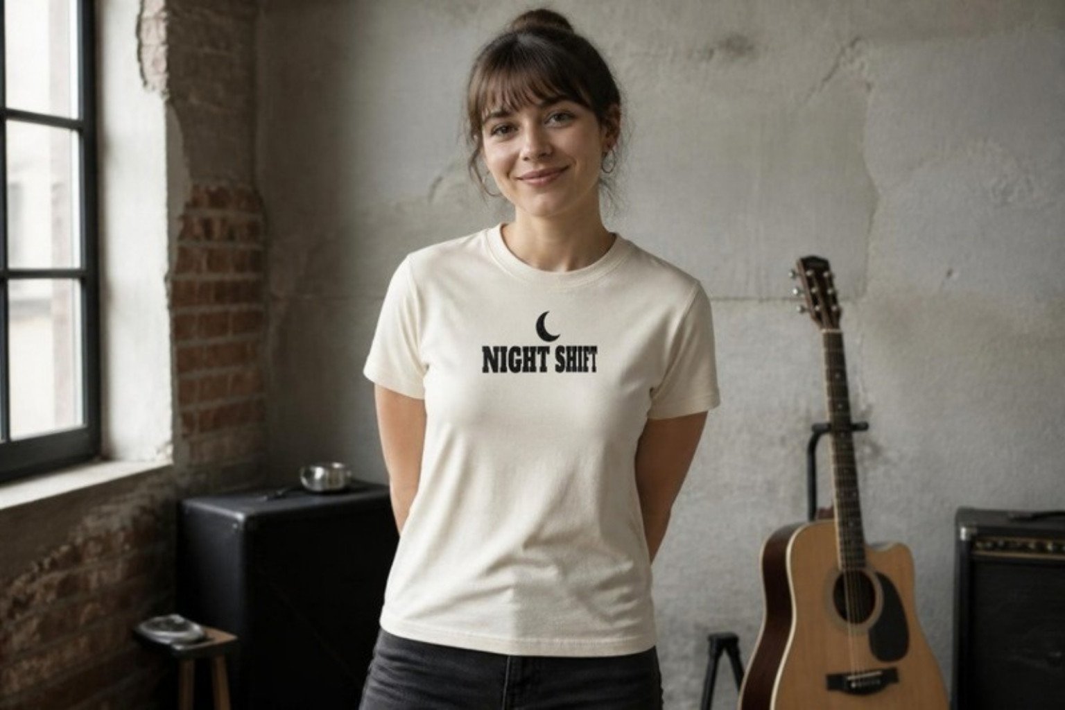 Demo: a singer-songwriter trying on a single sample cream tee printed with the fictional band name Night Shift